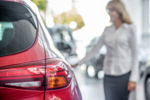 woman inspecting new car at dealership indoors 2026 01 05 05 50 00 utc